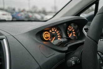 Voyant orange rond en forme de voiture allumé sur le tableau de bord d'une Peugeot